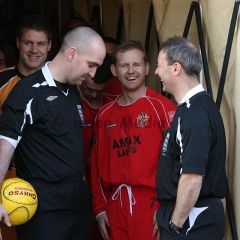 Captain Andy Tomlinson shares a joke with the match officials before the match